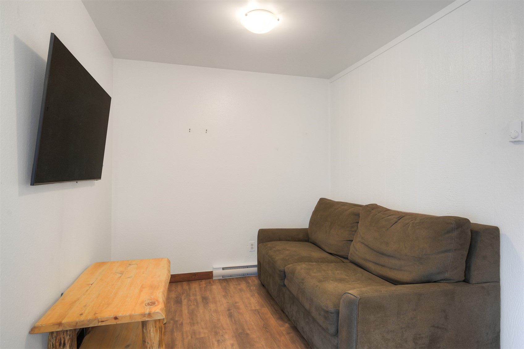 132 Illinois Gulch Road, Unit 3 Breckenridge, CO 80424 - Photo 13 of 32 a living room with a couch and a flat screen tv
