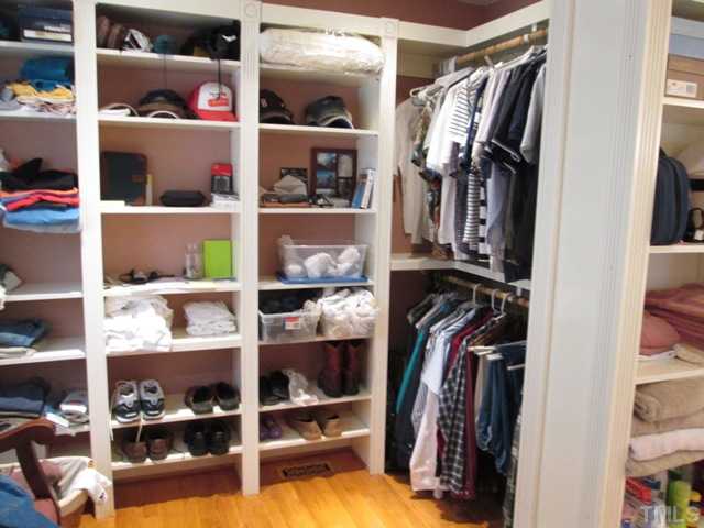 5305 Woodlaurel Court Raleigh, NC 27613 - Photo 21 of 25 incredible 1st floor master walk in closet! Custom built ins! You can expect this in just about EVERY bedroom closet in this home! Now THIS is a closet & it is WAY bigger than the picture, because we could not fit the entire closet in! WOW!