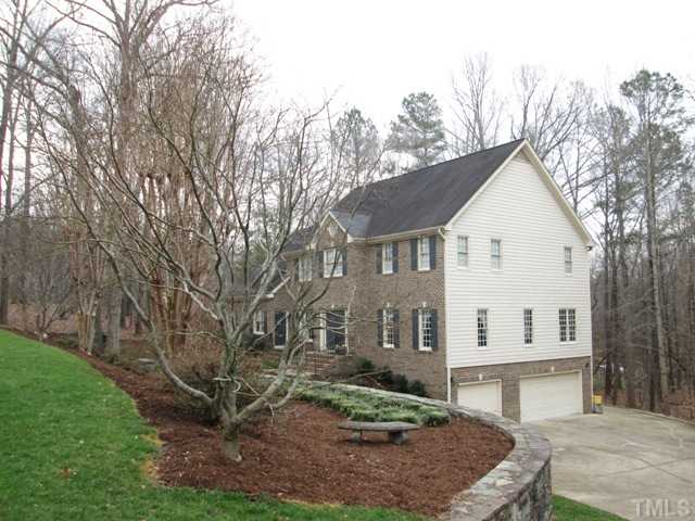 5305 Woodlaurel Court Raleigh, NC 27613 - Photo 4 of 25 Another view of your lovely brick front home shows the 3 car garage, the lovely stone wall, the mature trees and lovely landscaping and gorgeous lawn! Your family will love calling this house your home!