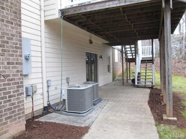 5305 Woodlaurel Court Raleigh, NC 27613 - Photo 6 of 25 The patio is underneath the deck and can be accessed from the steps from the deck, or through the french doors from the workshop in the basement.