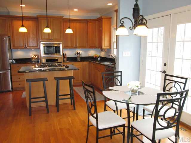 5305 Woodlaurel Court Raleigh, NC 27613 - Photo 9 of 25 Your updated kitchen features 42 inch oak cabinets with crown molding and under cabinet lighting that creates wonderful pools of lighting on your granite counter tops! This feature is always greatly appreciated when you use your counter for prep work!
