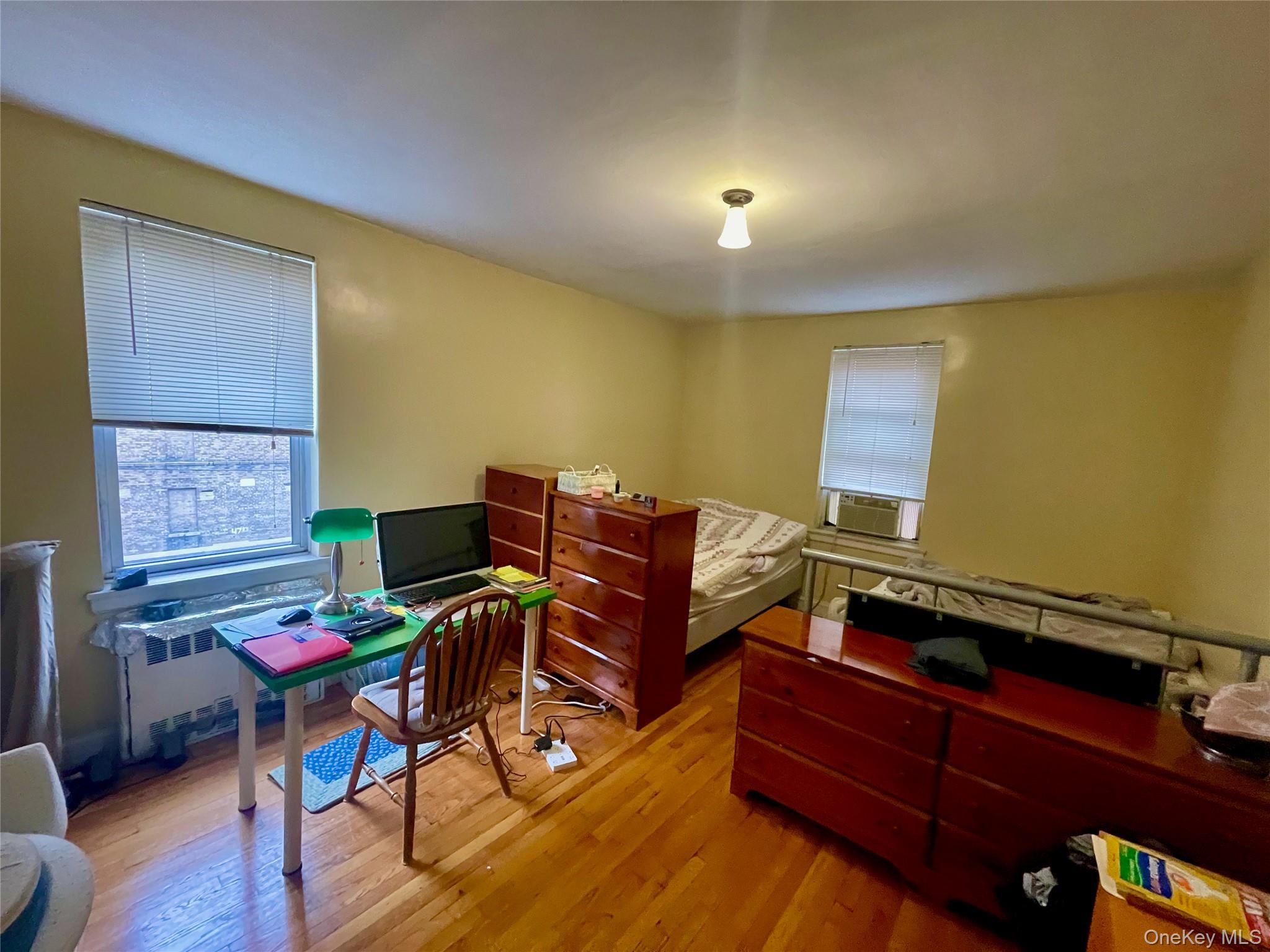 134-33 Blossom Avenue, Unit 3B Queens, NY 11355 - Photo 6 of 7 a work room with furniture and wooden floor