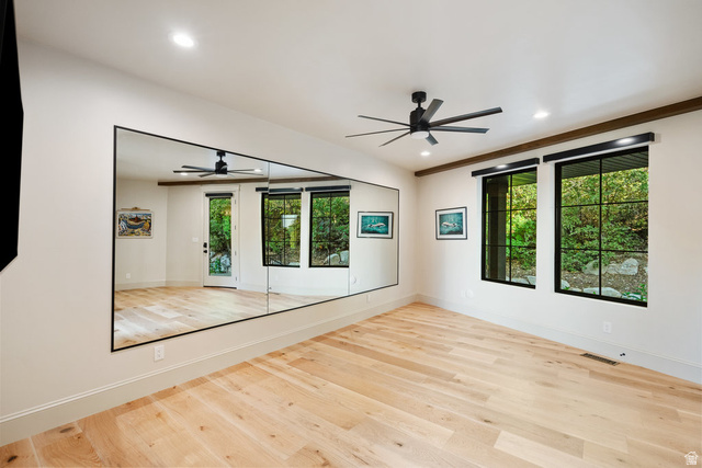 1141 South Oak Leaf Lane Springville, UT 84663 - Photo 64 of 147 Spacious room featuring light wood-finish flooring, a wall-mounted mirror, and black-framed windows