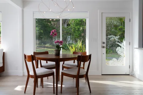a dining room with furniture and window