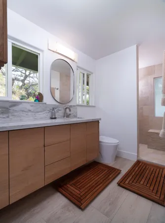 a bathroom with a toilet sink and mirror