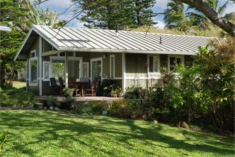 a front view of a house with a garden