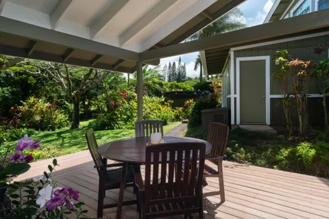 a view of a table and chairs in patio with potted plants