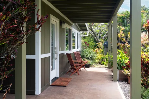 a view of patio with a table and chairs and potted plants