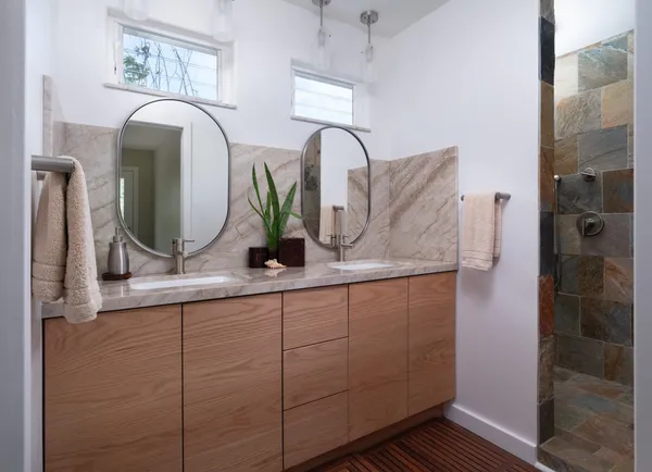 a bathroom with a double vanity sink and a mirror