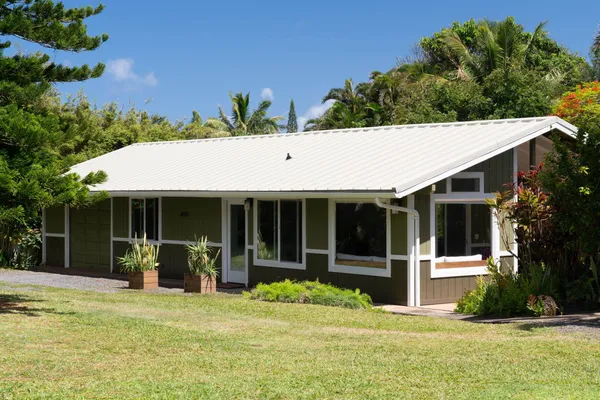 a view of house with outdoor space and swimming pool