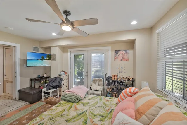 a bedroom with furniture and a large window