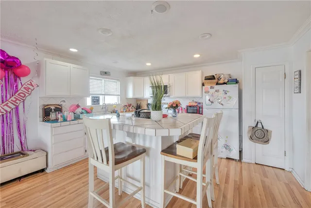 a dining room with furniture and a kitchen view