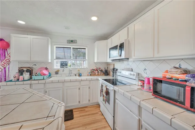 a kitchen that has a sink and a stove