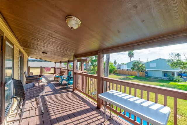 a balcony with wooden floor outdoor seating and furniture