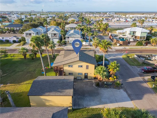 an aerial view of residential houses with outdoor space