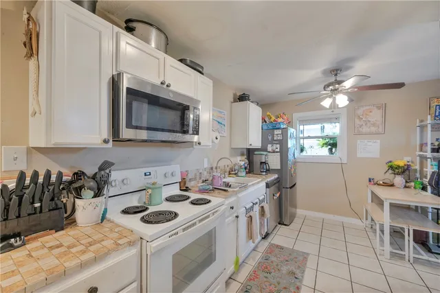 a kitchen that has a sink and a stove in it
