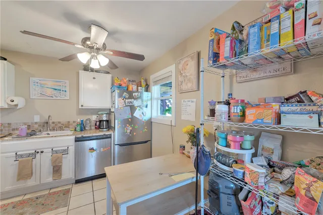 a kitchen with stainless steel appliances a sink and a refrigerator
