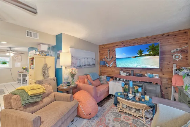 a living room with patio couch and a flat screen tv
