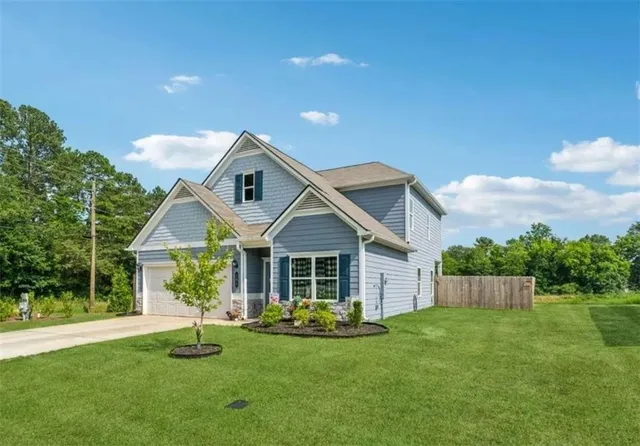 a front view of a house with a yard and porch