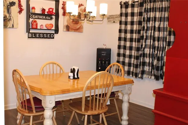 a dining room with furniture and wooden floor