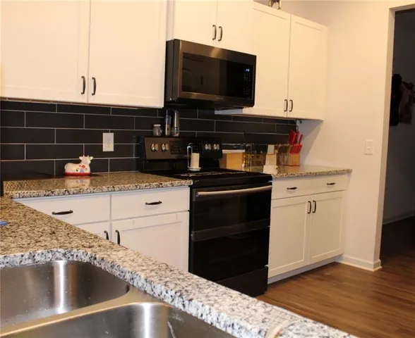 a kitchen with a sink and a stove top oven