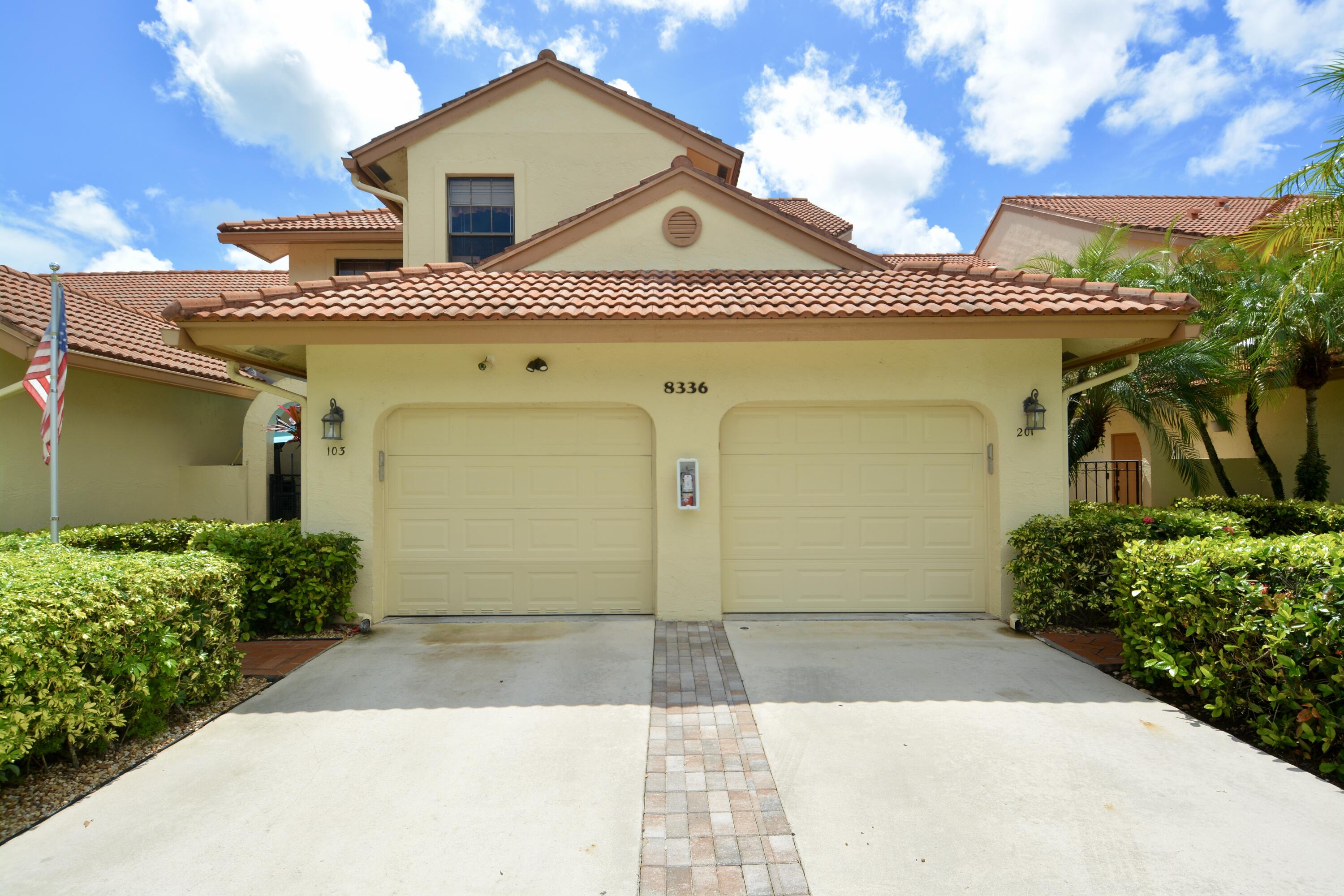 8336 Waterline Drive, Unit 201 Boynton Beach, FL 33472 - Photo 1 of 23 a front view of a house with garden