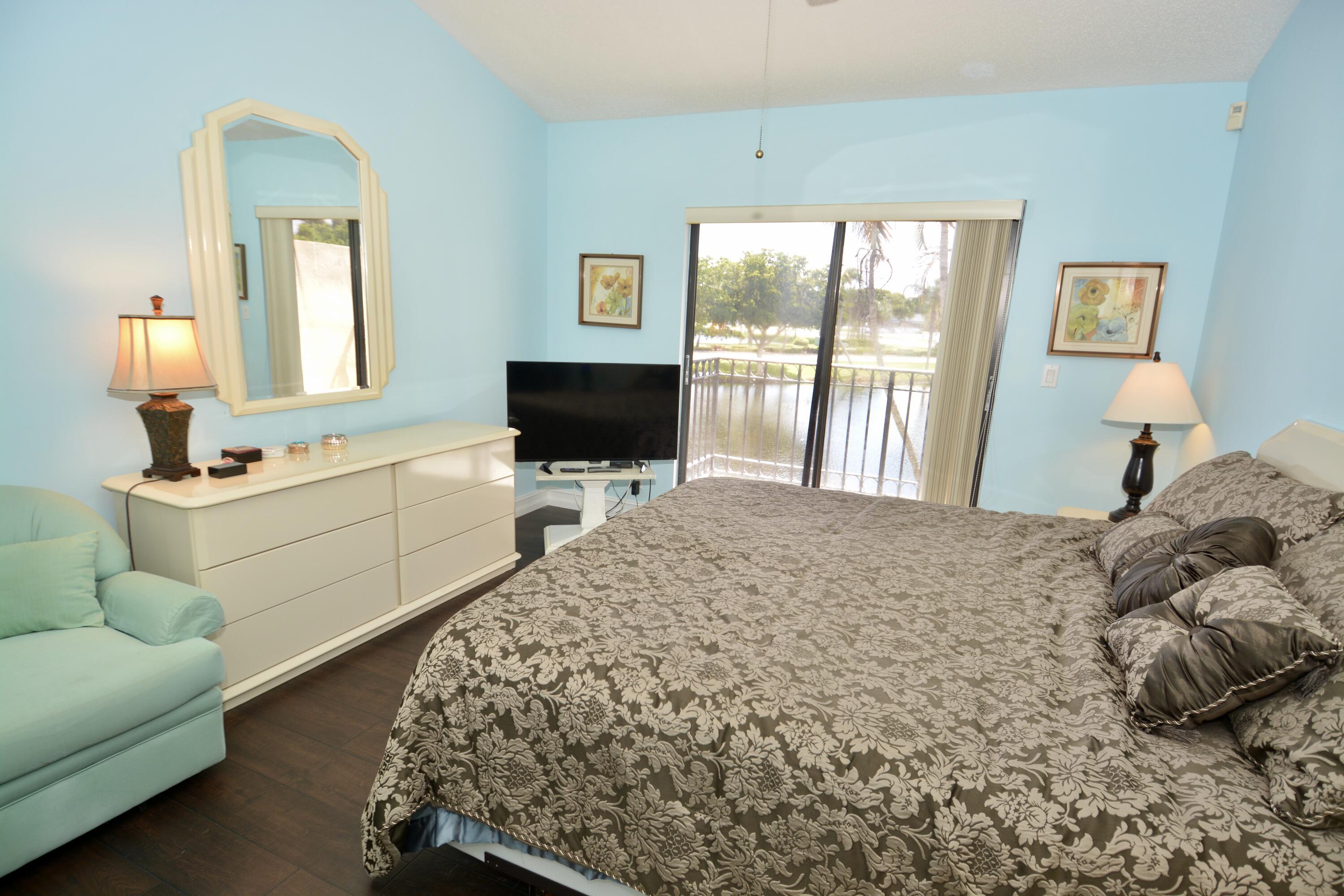 8336 Waterline Drive, Unit 201 Boynton Beach, FL 33472 - Photo 15 of 23 a living room with a couch and a flat screen tv