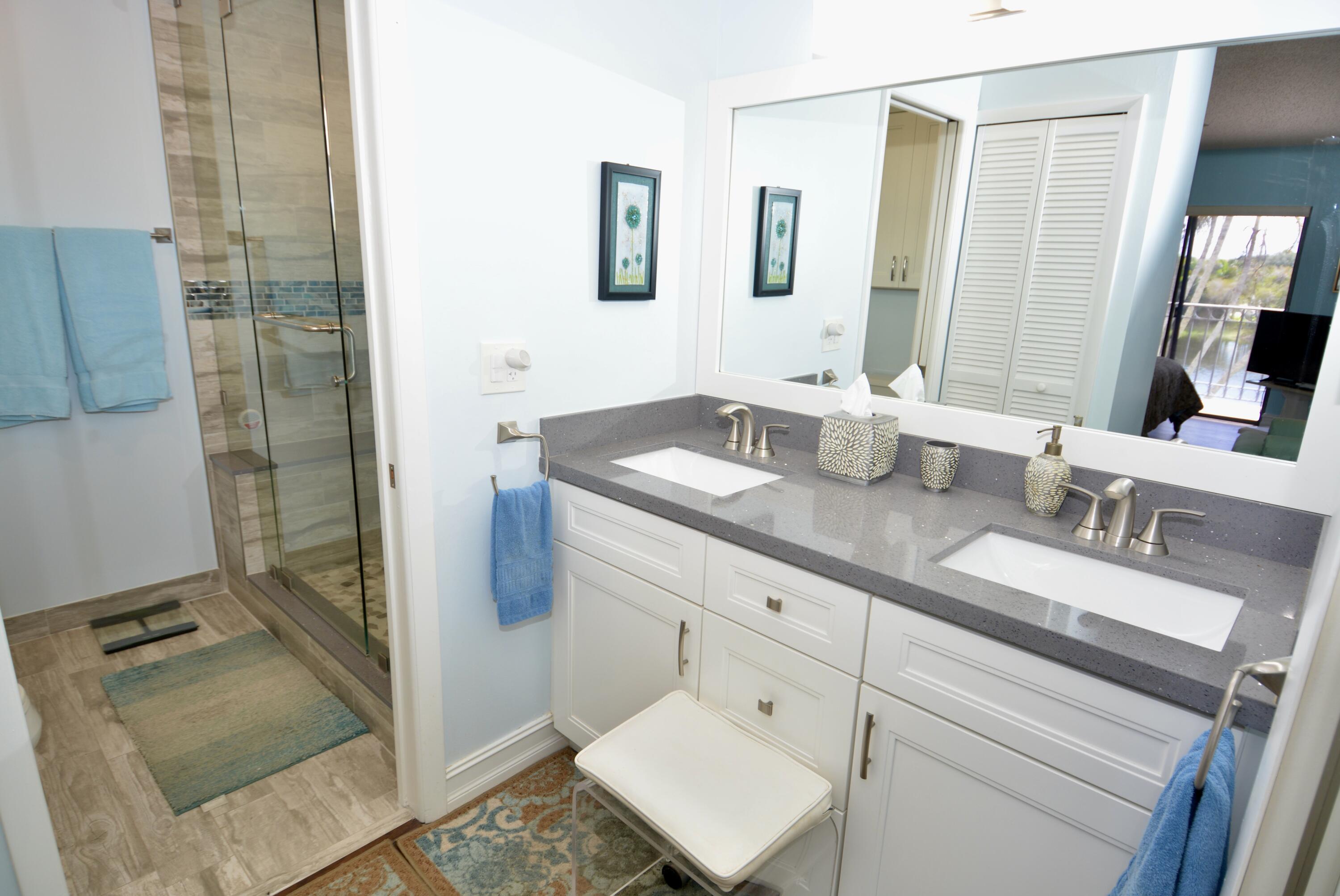 8336 Waterline Drive, Unit 201 Boynton Beach, FL 33472 - Photo 16 of 23 a bathroom with a granite countertop sink and a mirror