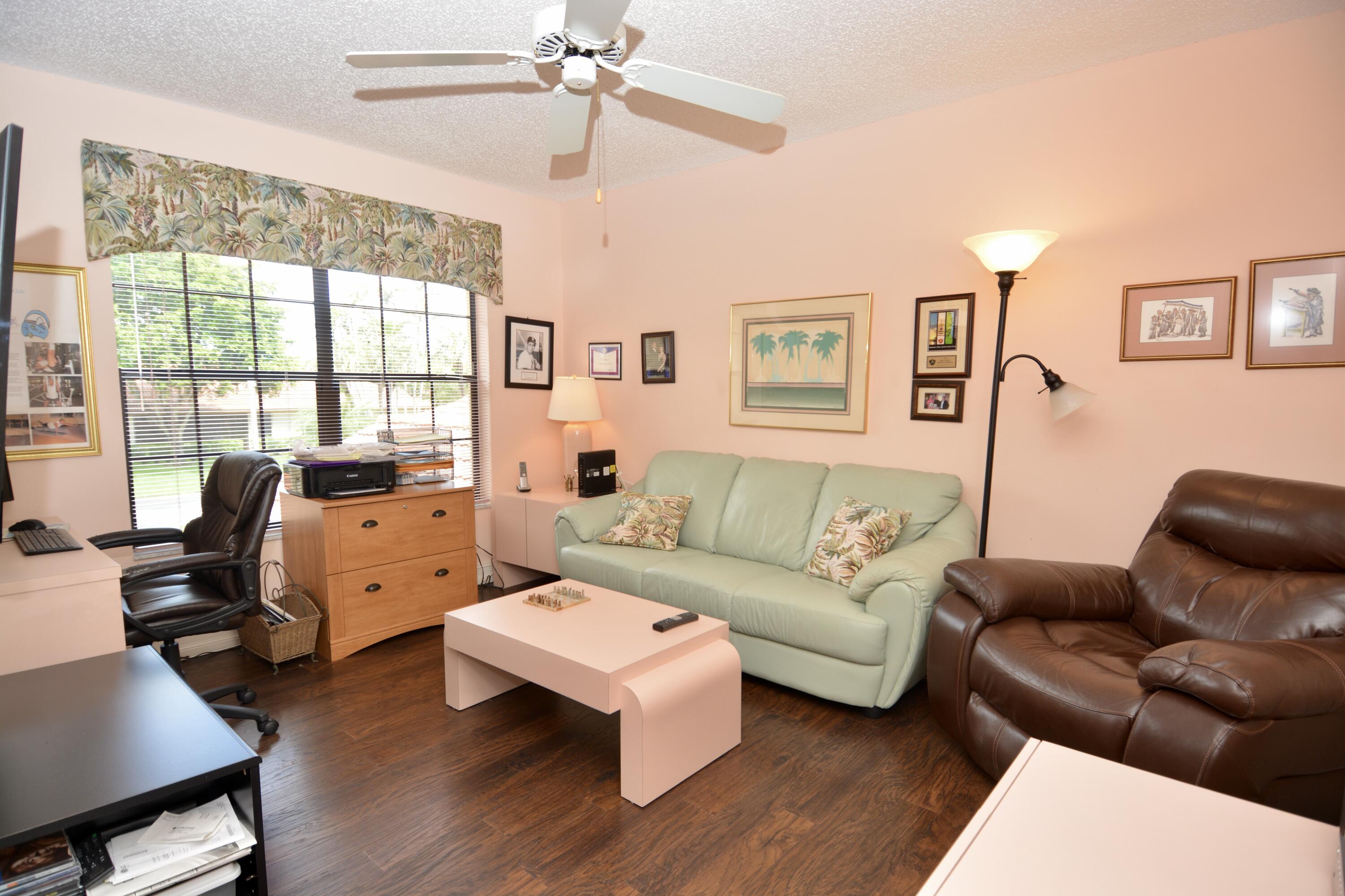 8336 Waterline Drive, Unit 201 Boynton Beach, FL 33472 - Photo 19 of 23 a living room with furniture flat screen tv and a large window