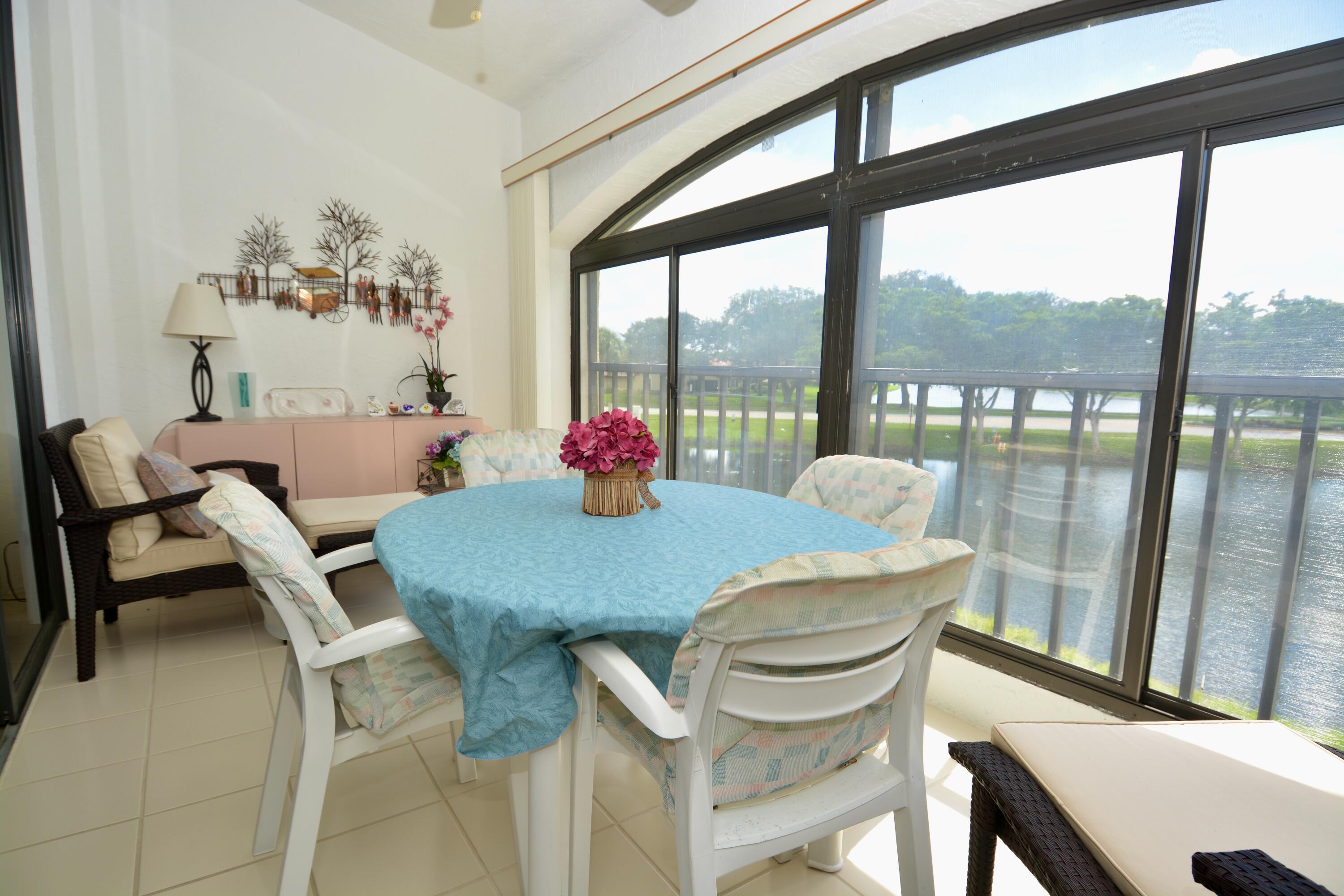 8336 Waterline Drive, Unit 201 Boynton Beach, FL 33472 - Photo 21 of 23 a view of a dining room with furniture and a window