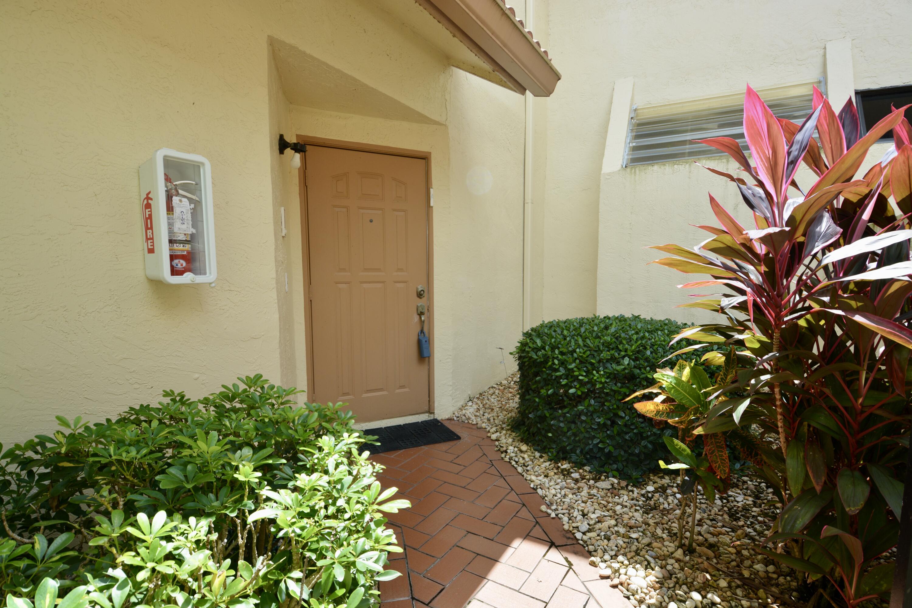 8336 Waterline Drive, Unit 201 Boynton Beach, FL 33472 - Photo 3 of 23 a plant that is in front of a door