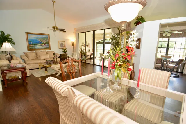 a living room with furniture chandelier and a large window