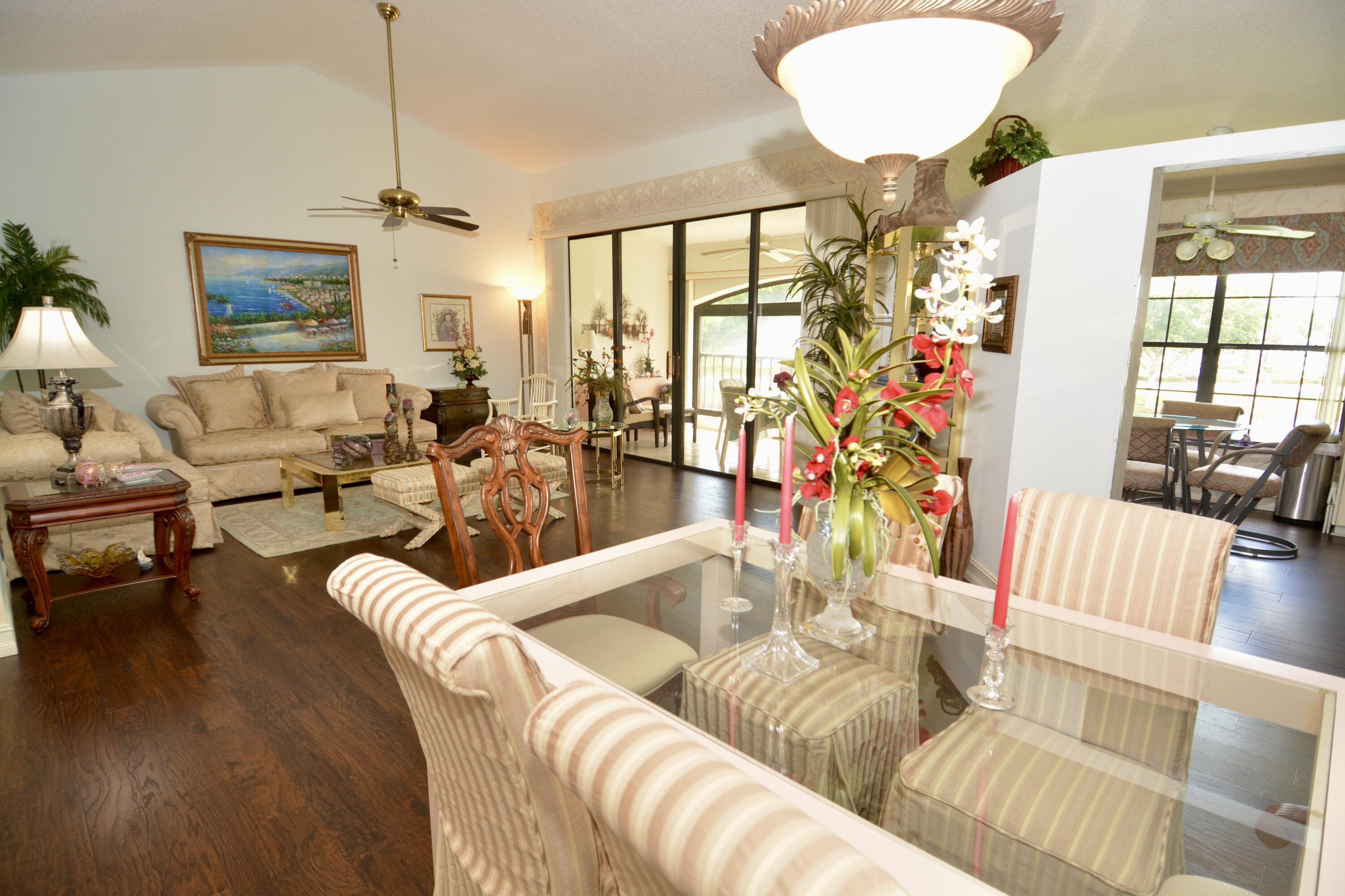 8336 Waterline Drive, Unit 201 Boynton Beach, FL 33472 - Photo 8 of 23 a living room with furniture chandelier and a large window