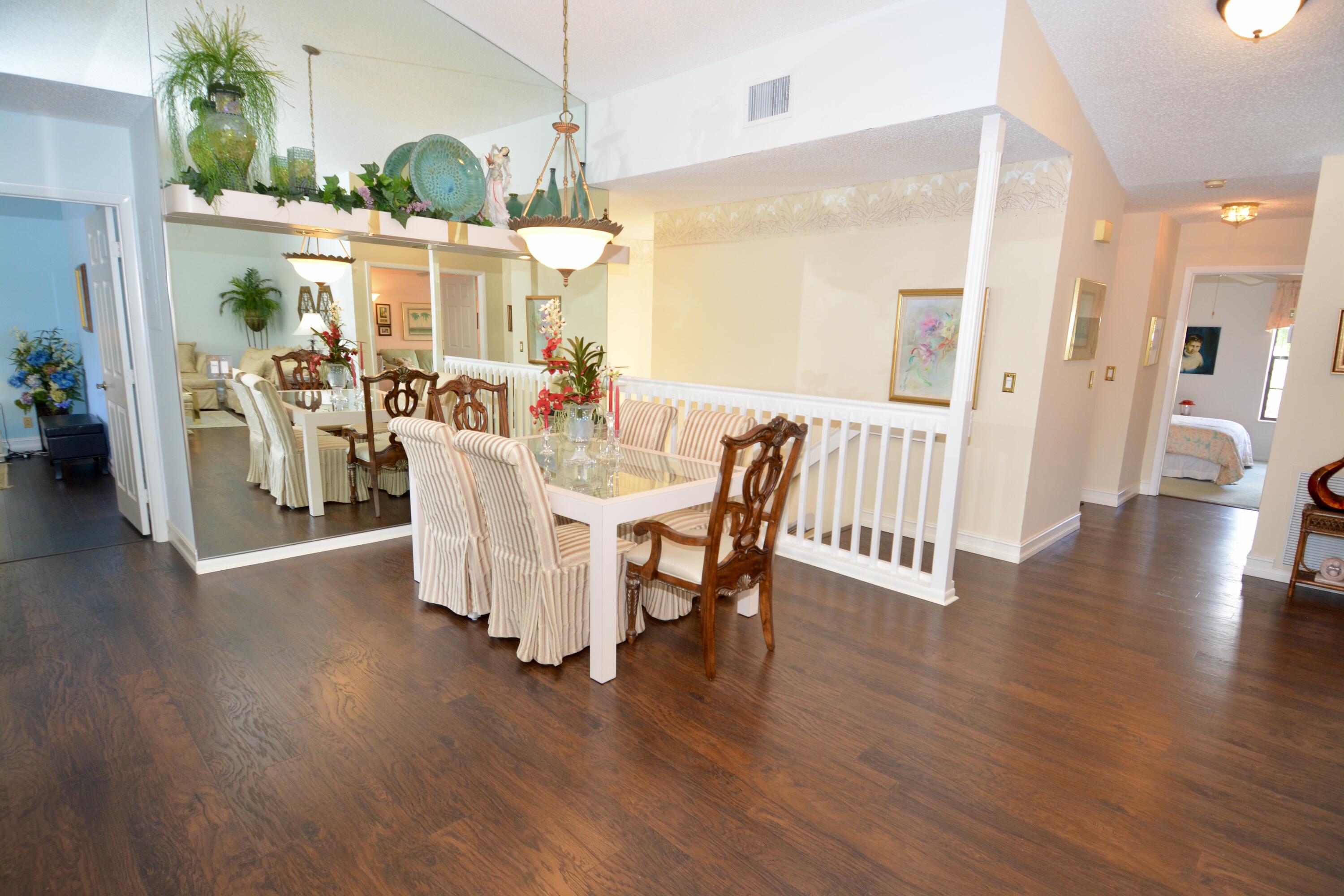 8336 Waterline Drive, Unit 201 Boynton Beach, FL 33472 - Photo 9 of 23 a view of a dining room with furniture and wooden floor