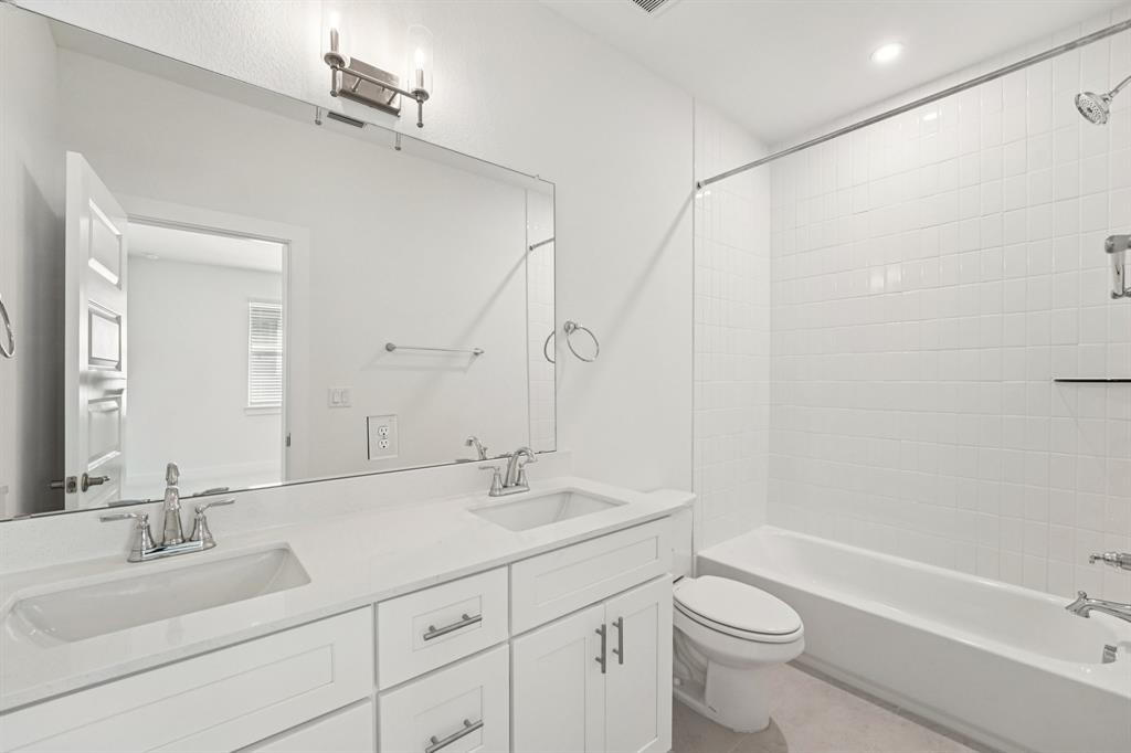 200 West 56th Street, Unit 8101 Austin, TX 78751 - Photo 12 of 13 This ensuite features dual quartz vanities and a shower/tub combo. (Sample photo of finishes and layout)