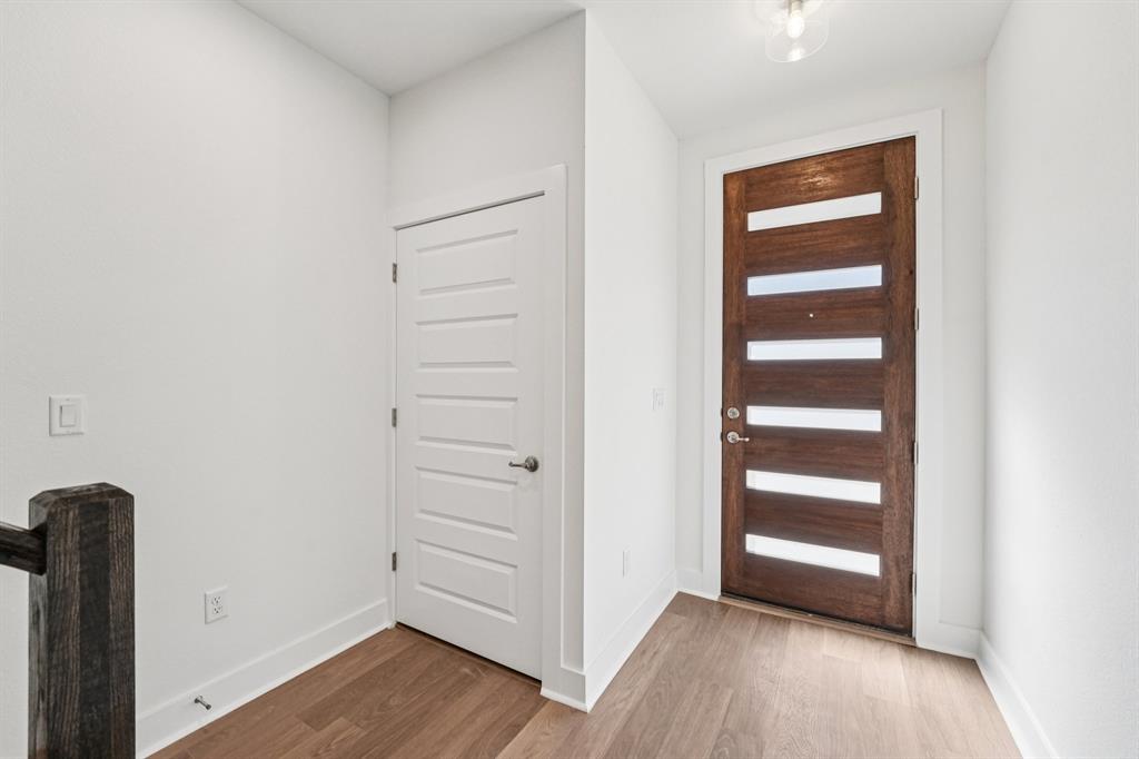 200 West 56th Street, Unit 8101 Austin, TX 78751 - Photo 5 of 13 A modern front door, clean lines, and warm RevWood flooring give the lower level a simple, polished first impression (Sample photo of finishes and layout)