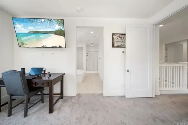 a view of a workspace with furniture and a potted plant