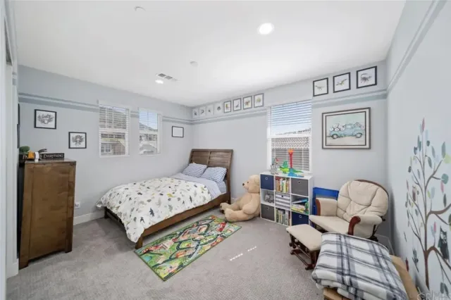 a bedroom with a bed and a couch