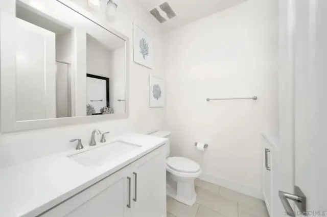 a bathroom with a sink toilet and a mirror