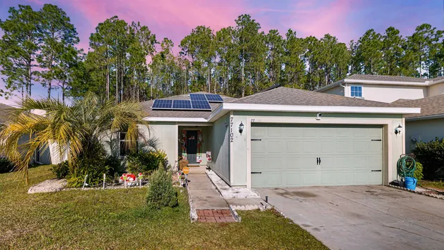 a view of a house with a yard and tree s