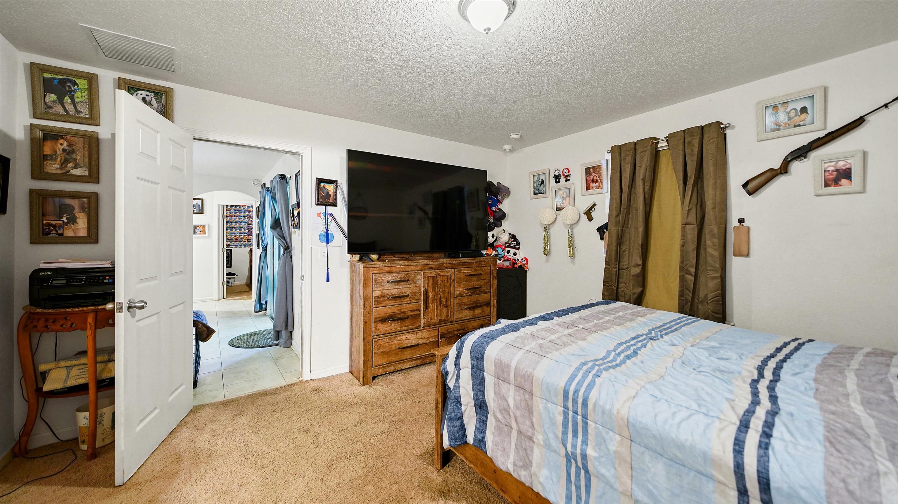 77102 Crosscut Way Yulee, FL 32097 - Photo 12 of 21 a bedroom with a bed and a flat screen tv