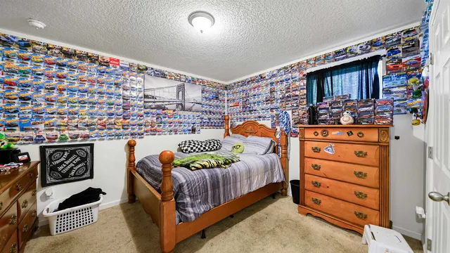 a bedroom with a bed and a dresser