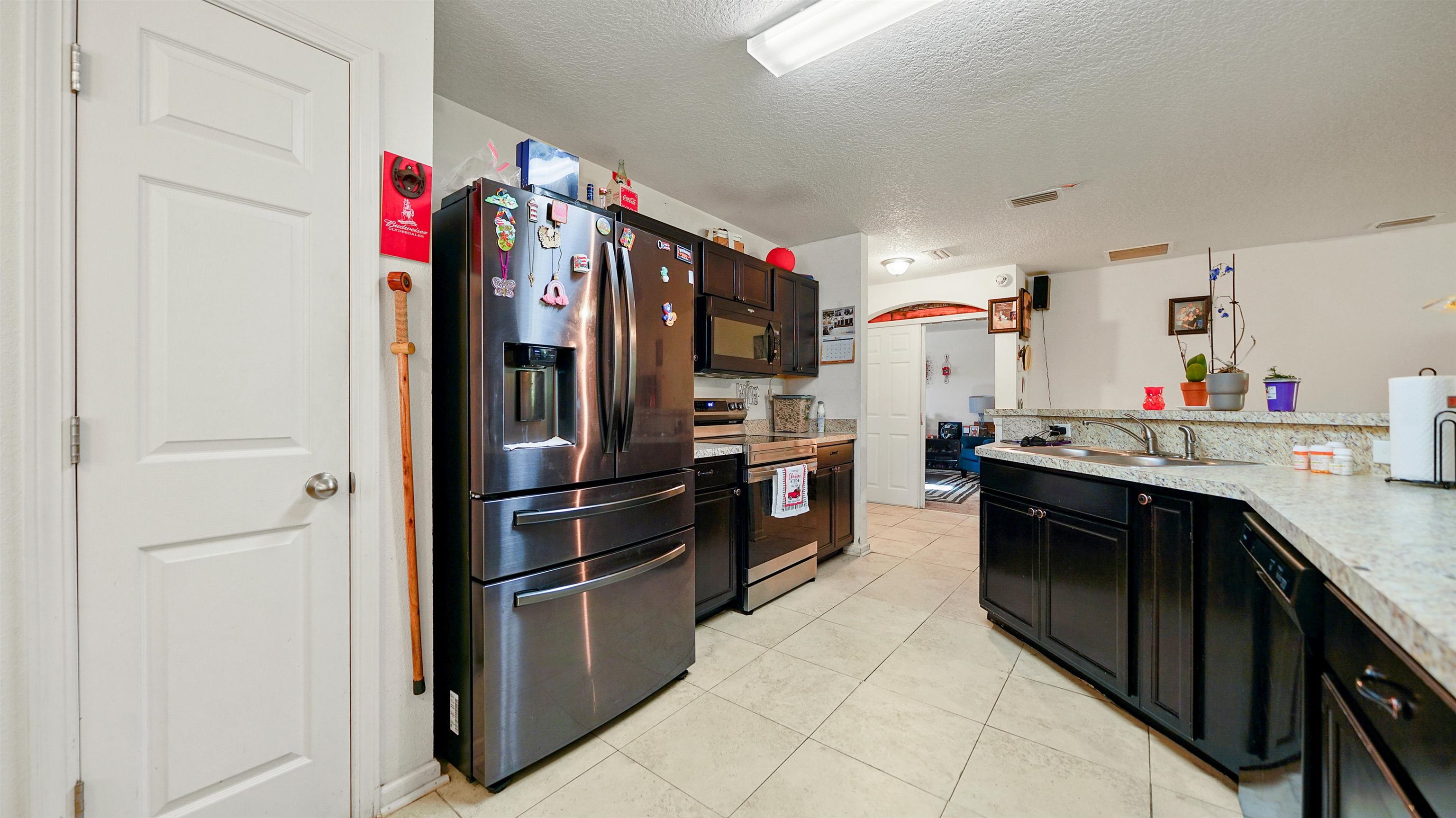 77102 Crosscut Way Yulee, FL 32097 - Photo 6 of 21 a kitchen with stainless steel appliances granite countertop a refrigerator and a stove