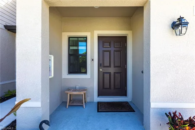 a view of an entryway of house and livingroom with wooden floor