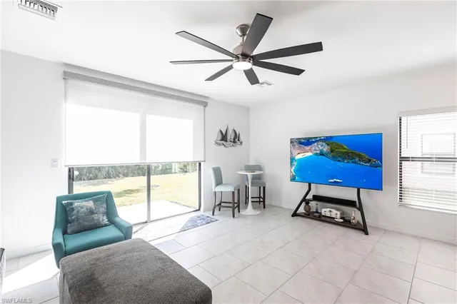 a living room with furniture and a ceiling fan