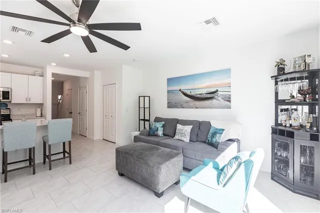 a living room with furniture and kitchen view