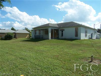 8445 Bamboo Road Fort Myers, FL 33967 - Photo 3 of 5 a view of a house with a yard