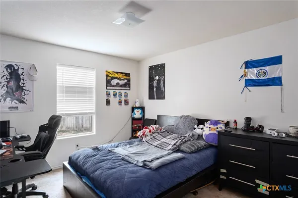 a bedroom that has a bed and a furniture