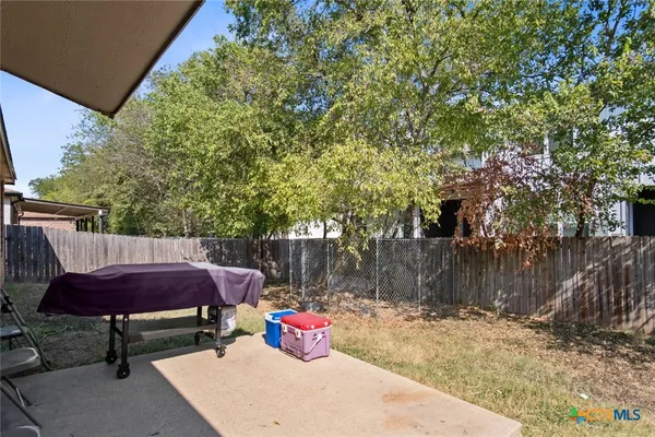 a sitting area with furniture and wooden fence