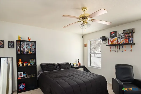 a bedroom with a bed and a chair